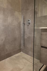 a shower with a glass door in a bathroom at Olivia Hotel in Durrës +117 photos