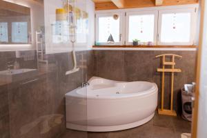 a bathroom with a tub and a sink at LoSteLaDa sul lago di Como in Colico +54 photos