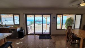 a kitchen with a view of the beach through sliding glass doors at Casa Evita in Puerto Peñasco
