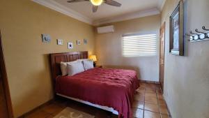 a bedroom with a bed and a ceiling fan at Casa Evita in Puerto Peñasco