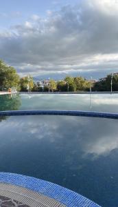 a pool of water with the reflection of the sky at Appart hôtel Cabo dream in Cabo Negro