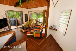 a living room with a couch and some windows at Ranked 1 in the Izu Mount Fuji from the villa in Izunokuni