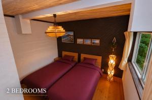 a bedroom with two beds and a window at Ranked 1 in the Izu Mount Fuji from the villa in Izunokuni