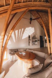 a living room with a couch and a table at Mambo Lombok in Kuta Lombok