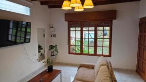 a living room with a couch and a window at Casa Verde 3 in Carhué