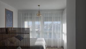 a bedroom with a bed and a large window at Estudio Bellavista La Colina in Torremolinos +27 photos