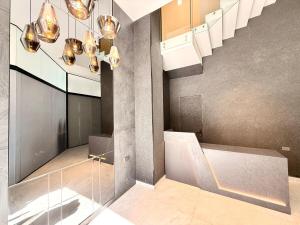 a lobby with a staircase and lights in a building at Forty 125 in Tarija