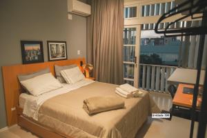 a bedroom with a bed with two towels on it at Rio Branco 688 - Hospedagem Premium in Santa Maria