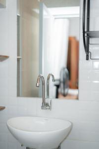 a white sink in a bathroom with a mirror at Muyuterra in Moyobamba