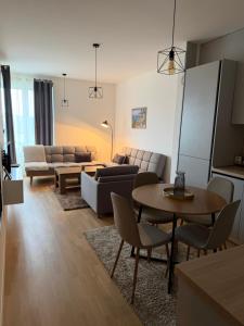 a living room with a couch and a table at Ribica Apartments in Ilidža