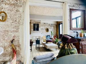 a room with a brick wall and a living room at Legions Retreat in Antwerp
