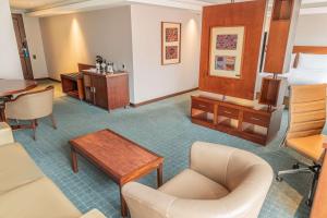 a hotel room with a bed and a desk at GHL Hotel Capital in Bogotá +79 photos
