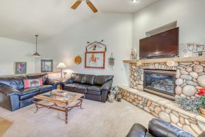 a living room with leather couches and a fireplace at Lookout Ridge 63 in Dillon