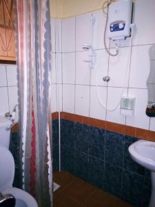 a bathroom with a shower and a sink at J residence Motel in Entebbe +44 photos