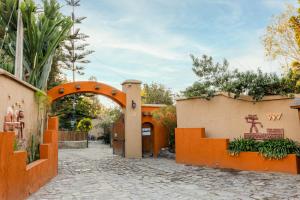an entrance to a house with an orange gate at Cabañas Refugio El Molle in El Molle