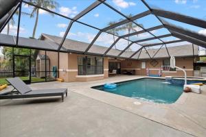 a swimming pool with a glass roof over it at Elegant, 4 BDR house with a pool and BBQ in Wellington