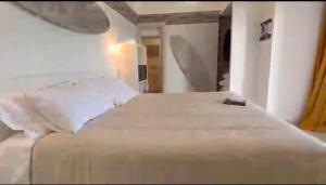 a bedroom with a large bed with white sheets and pillows at Dolce Vita Terrace On the Ocean - Veranda Sul Mare in Vieste