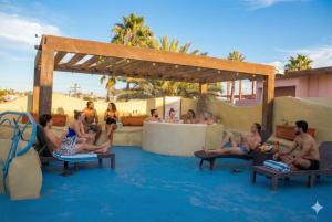 a group of people sitting in the water at a resort at Hotel Festival Plaza Playas Rosarito in Rosarito