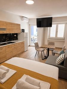 a living room with a couch and a table at Apartmani Morѐll 1 in Novalja