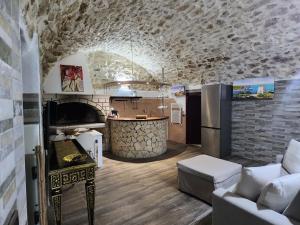 a kitchen with a couch and a counter in a room at Dolce Vita Terrace On the Ocean - Veranda Sul Mare in Vieste