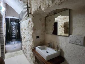 a bathroom with a sink and a mirror at Dolce Vita Terrace On the Ocean - Veranda Sul Mare in Vieste +7 photos