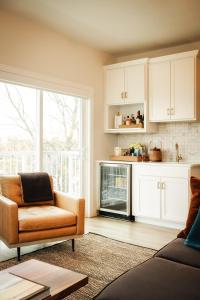 a living room with a couch and a chair at Dexter Hotel in Elk Rapids