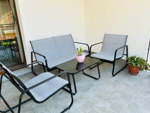 two chairs and a table with a plant on a patio at La Curt by Ambroeus apartments in Inzago