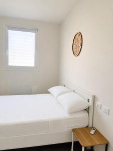 a bedroom with a bed and a clock on the wall at La Curt by Ambroeus apartments in Inzago