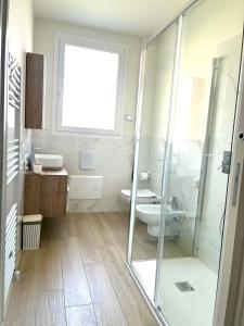 a bathroom with a shower and a toilet and a sink at La Curt by Ambroeus apartments in Inzago +4 photos