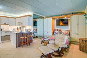 a kitchen and living room with a couch and a table at Colorful Virginia Beach Studio - Steps to Beach! in Virginia Beach