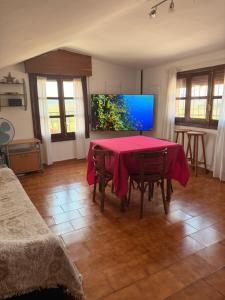 a dining room with a red table and chairs at Villa Terrazos in Terrazos