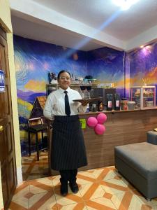 a man is standing in front of a bar at Casa Adelita in Huehuetenango
