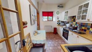 a kitchen with a table in the middle of it at The Byre in Banbury +17 photos