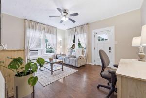 a living room with a couch and a ceiling fan at Cozy 1BR Cottage w Kitchen & Laundry in Lafayette