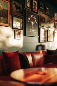 a couch with a table and pictures on the wall at Dexter Hotel in Elk Rapids