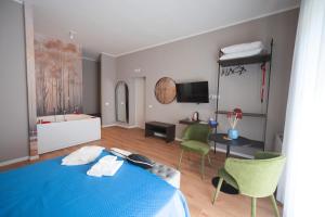 a bedroom with a blue bed and a living room at Vittorio Veneto Dimore in Bari