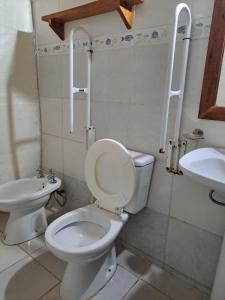 a bathroom with a toilet and a sink at Las Cabañas in Santo Tomé