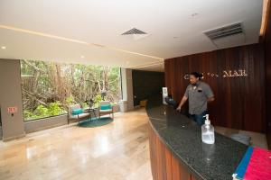 a man standing at a counter in a room at Depa MAJUM Playa del Carmen in Playa del Carmen +115 photos