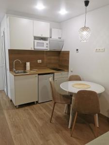 a kitchen with a table and chairs and a sink at Happy Home2 in Cahul