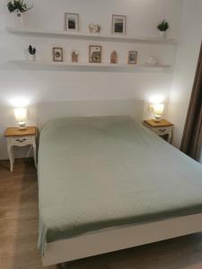 a bedroom with a bed with two lights on two tables at Happy Home2 in Cahul