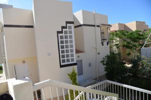 a white building with a window on the side of it at Virginia beach village in El Alamein