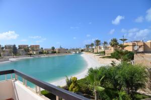 a view of a beach from a balcony at Virginia beach village in El Alamein