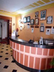 a bar in a restaurant with pictures on the wall at J residence Motel in Entebbe