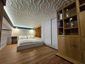 a bedroom with a bed on a wooden floor at Vision Luxury Apartment Rynek in Wrocław