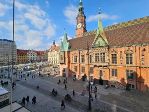 a large building with a clock tower on top of it at Vision Luxury Apartment Rynek in Wrocław