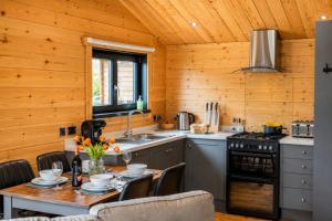 a kitchen with wooden walls and a table with chairs at 2 Bed in Nafferton oc-o31954 in Nafferton