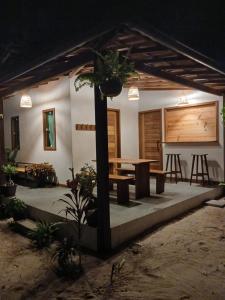a house with a table and a dining room at Casa bambu atins in Atins