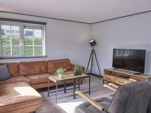 a living room with a couch and a tv at t Kaatsheuveltje 1 in Kaatsheuvel