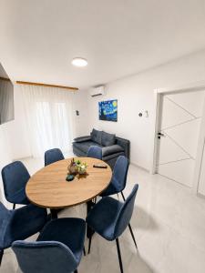 a living room with a table and chairs and a couch at Apartmani Morѐll 1 in Novalja