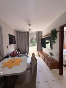 a living room with a table and a couch at Season Ilhéus in Ilhéus